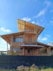 a house with a roof on top of it at Casa Bambú Galápagos in San Cristobal