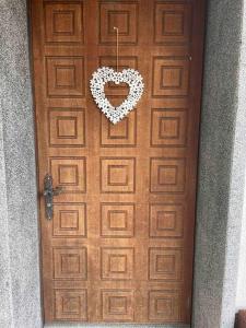 a wooden door with a heart hanging on it at Apartment in Swiss Chalet Träumli in Meierskappel