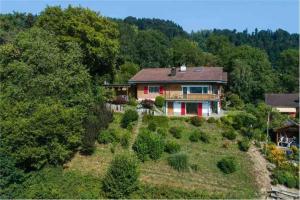 a house on top of a hill with trees at Apartment in Swiss Chalet Träumli in Meierskappel