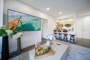 a living room with a large painting on the wall at 4 SantaMonica De Lux in Los Angeles
