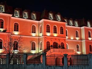a large orange building with lights on it at night at Hostel Prishtina Backpackers in Prishtinë