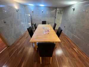 una sala de conferencias con mesa de madera y sillas en Camden, London, Holloway Rooms 20 Busby Place, NW5 2SR, en Londres