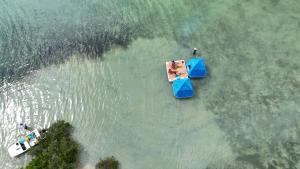 two boats in the water with people on them at Bonnethead Key Floating Campground and Private Island in Key West
