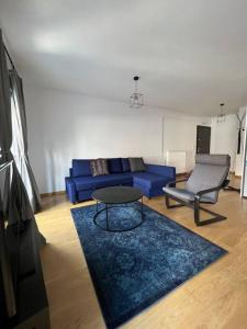 a living room with a blue couch and a table at Iris Luxury Apartment in Ioannina