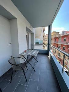 a balcony with a table and chair on a balcony at Iris Luxury Apartment in Ioannina