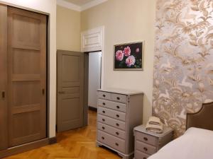 a bedroom with a bed and a dresser and a door at Al Pacino apartment in Riga