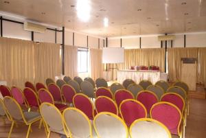 a room with a bunch of chairs and a table at karthika residency in Cochin