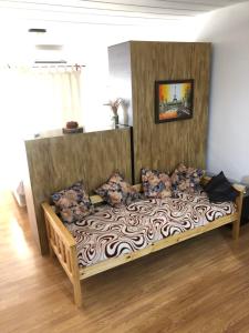 a large wooden bed in a living room with at Apartamento El Hornero in San Rafael