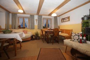a living room with a table and a dining room at Pension Marianne - Chiemgau Karte in Inzell