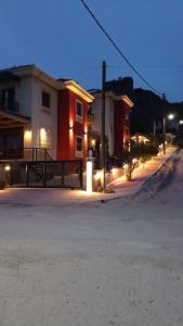 a building with lights on a street at night at Dominique House Meteora in Kalabaka +4 photos