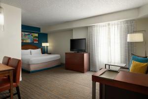 a hotel room with a bed and a television at Residence Inn Orlando Lake Buena Vista in Orlando