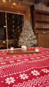 a christmas tree sitting in a room with a table with a christmas table at Maison au calme sur une propriété de 40 hectares in Bassillac