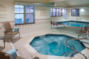 a large pool with a hot tub in a room at Residence Inn by Marriott Saratoga Springs in Saratoga Springs