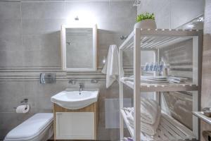 a small bathroom with a sink and a toilet at V&V Central Apartment in Pyli Vol. 2 in Pýli