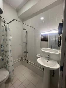 a bathroom with a sink and a shower at GUEST INN HOTEL in Dubai