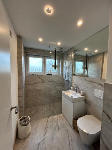 a bathroom with a toilet and a sink and a shower at Sweet Home in Meerbusch in Meerbusch +1 photo