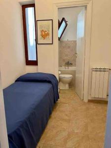 a bedroom with a bed and a bathroom with a toilet at Green & relax near S.Peter in Rome