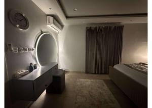 ein Schlafzimmer mit einem großen Spiegel und einem Bett in der Unterkunft شقة تتكون من صالة وغرفة ومطبخ, حي النرجس in Riad