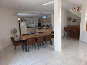 a kitchen and dining room with a table and chairs at Casa Graciosa in Tarrafal