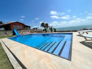 una piscina con vistas al océano en Villa Amarelo en Beberibe