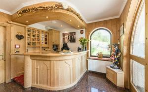 an ornate kitchen with a large island in a house at Garni la Bercia in Selva di Val Gardena