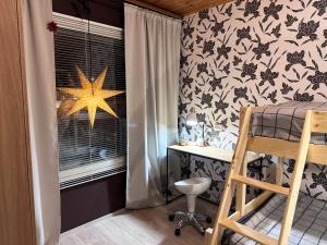 a bedroom with a desk and a star on the wall at Linnunvilla with sauna in Rovaniemi +41 photos