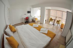 a large white bed in a room with a table at ARDA AKSOY OTEL 