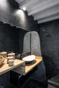 a bathroom with a sink and a mirror at Sea Rock & Sky Private Mykonos Residence in Merchia Beach