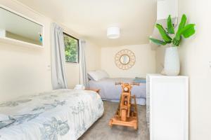 ein kleines Schlafzimmer mit einem Bett und einem Fenster in der Unterkunft Lavaud Delight - Akaroa Holiday Home in Akaroa