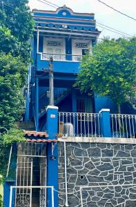 a blue building with a staircase in front of it at Panorama Inn in Rio de Janeiro