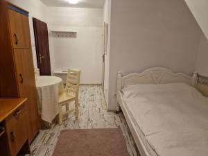 a bedroom with a bed and a table and a chair at Agroturystyka Gramburg in Zblewo +77 photos
