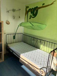 a bedroom with a bed with a glass shelf on the wall at Helle Wohnung mit Wintergarten, Terrasse und Garten in Bad Liebenzell