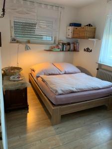 a bedroom with a bed and a table at Helle Wohnung mit Wintergarten, Terrasse und Garten in Bad Liebenzell