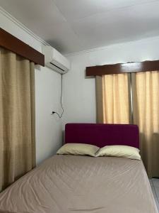 a bedroom with a bed and a window at Ziara Apartments in Nadi