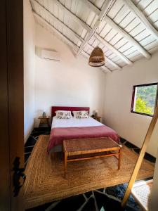 a bedroom with a large bed and a large window at Casa da Loba in Casas Novas de Marés