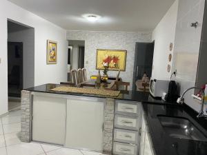 a kitchen with a counter top and a table at Apartamento grande 900m do centro in Diamantina +14 photos
