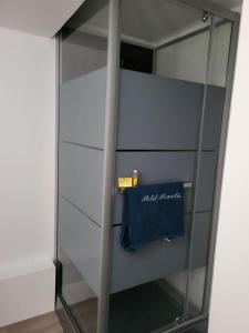 a glass closet with a blue bag in it at PETIT PARADIS in La Bruffière +6 photos
