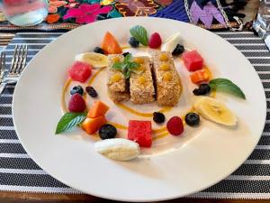 a plate of food with fruit on a table at Eternal Spring in Antigua Guatemala