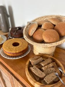 a table with two baskets of bread and a plate of cookies at La Bahianita in Itacaré