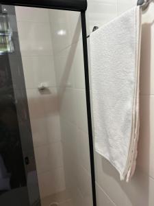 a towel hanging on a shower door in a bathroom at La Bahianita in Itacaré