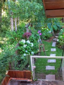 a garden with a cage full of flowers at Recanto dos Jasmins Gramado in Gramado