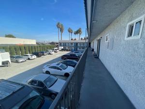 a group of cars parked in a parking lot at Travel Inn Motel in Anaheim
