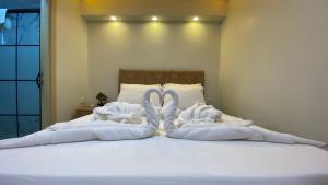 two towels are made to look like swans on a bed at Pilot hotel in Arnavutköy