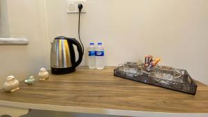 a counter with a coffee maker and water bottles on it at Pilot hotel in Arnavutköy