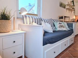 a white bed with pillows on it in a room at Familientraum auf 120 m2 in Rostock in Rostock