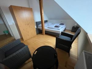 a room with a bed and two chairs and a table at MWM Gästehaus -Zimmer in Meine