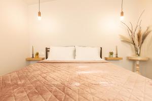 a bedroom with a large bed with two pillows at Poepoe Home Trikala in Tríkala