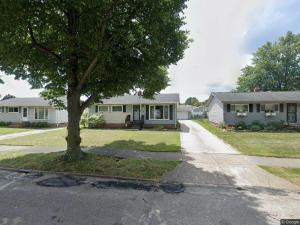 a house with a tree in the middle of a street at Quiet & Cozy home near Hospitals in Cleveland