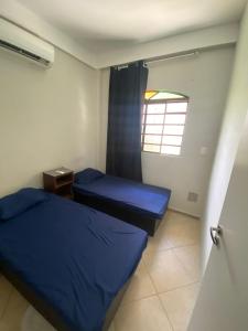 a small room with two beds and a window at Hostel Concordia/Nova floresta in Belo Horizonte