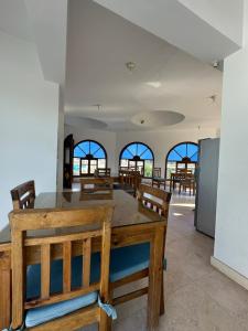 a dining room with a wooden table and chairs at El Salam hotel in Dahab